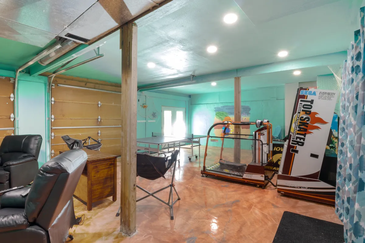 A fun, casual recreation room featuring a ping pong table, an arcade game machine, and comfy reclining chairs. The environment invites friendly competition, gaming, and relaxation, perfect for both kids and adults.